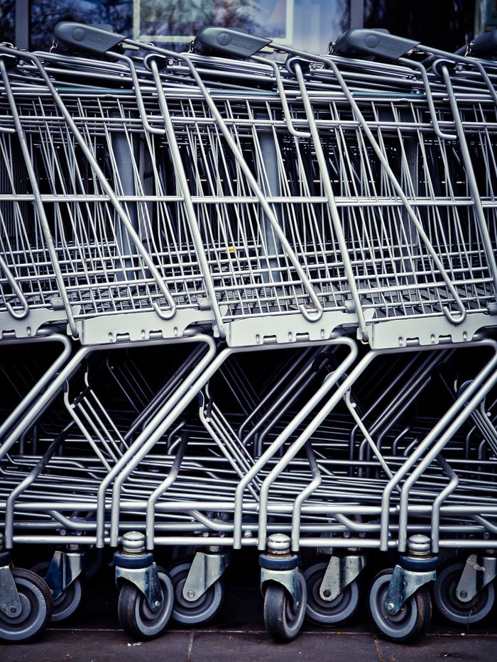 Services Rows of stacked metal shopping carts forming a repetitive industrial pattern.